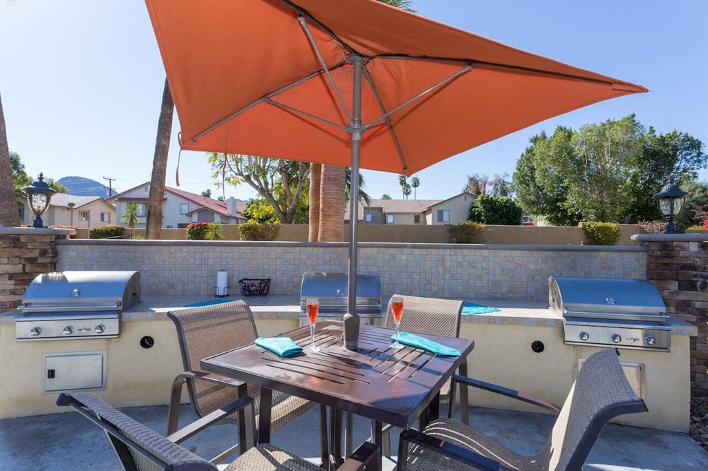 a patio with a table and chairs and an umbrella