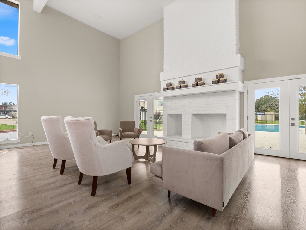 a living room with couches and chairs and a fireplace