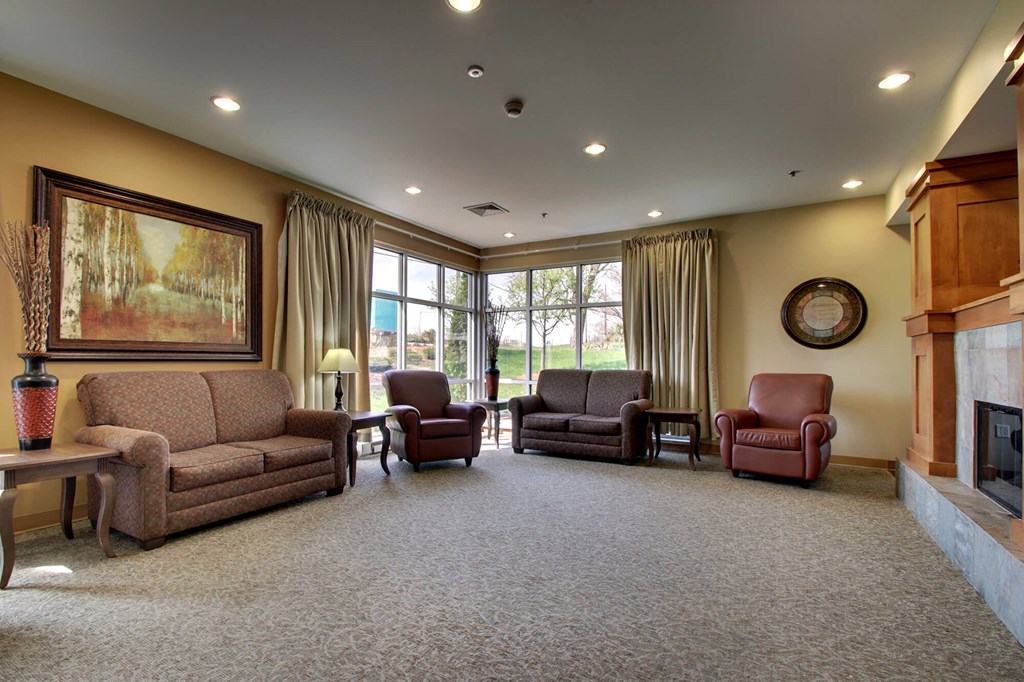 a living room with couches and chairs and a fireplace