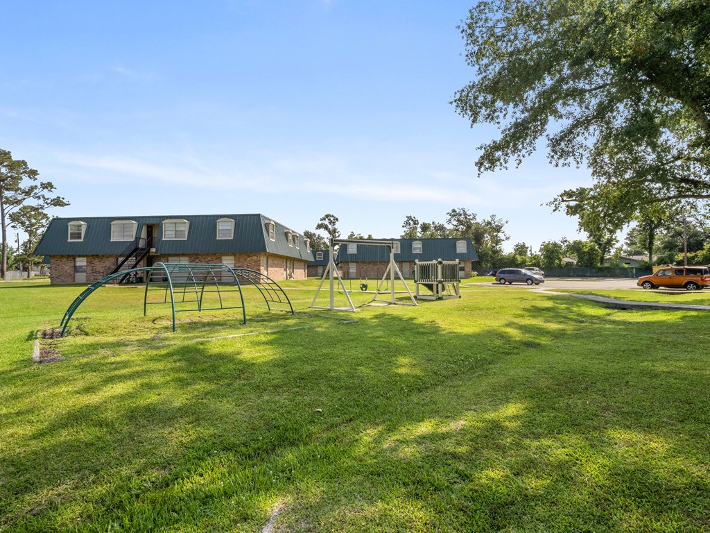 a swing set in a park in front of a house