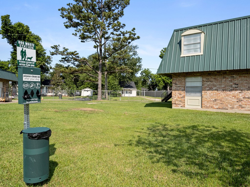 a sign in the grass in front of a building