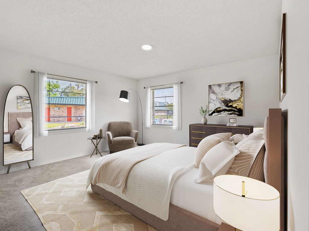 a bedroom with a large bed and a mirror