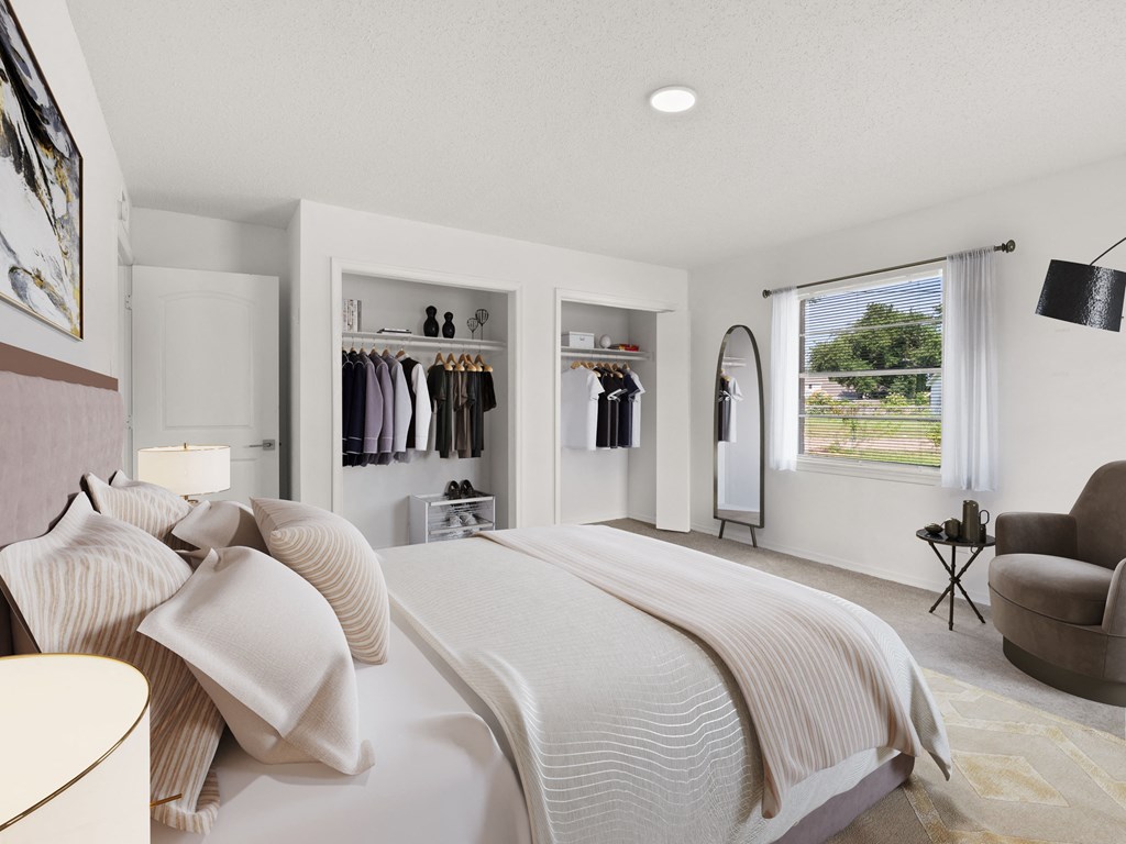 a white bedroom with a large bed and a closet
