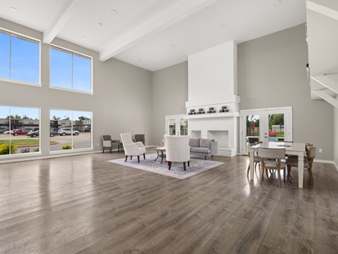 a living room with a fireplace and a table and chairs
