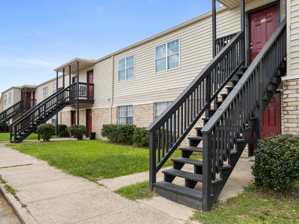 a view of the exterior of an apartment building with stairs