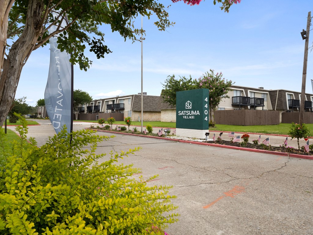 the sign at the end of a road with a building