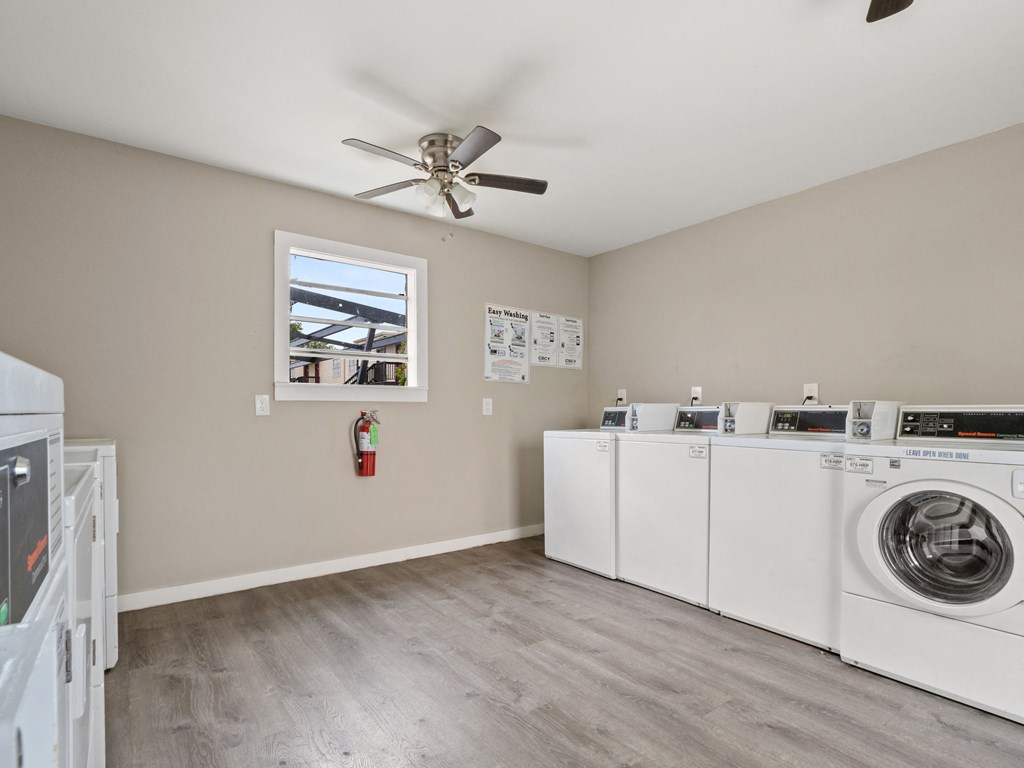 a laundry room with washer and dryer and a ceiling fan