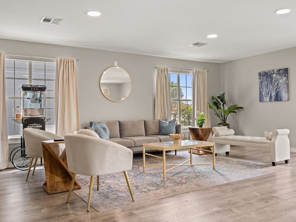 a living room with a couch and chairs and a table
