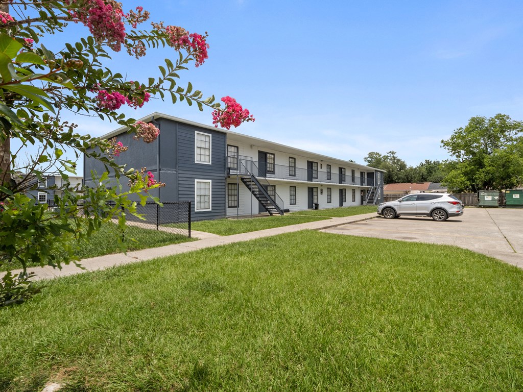 a car parked in front of an apartment building
