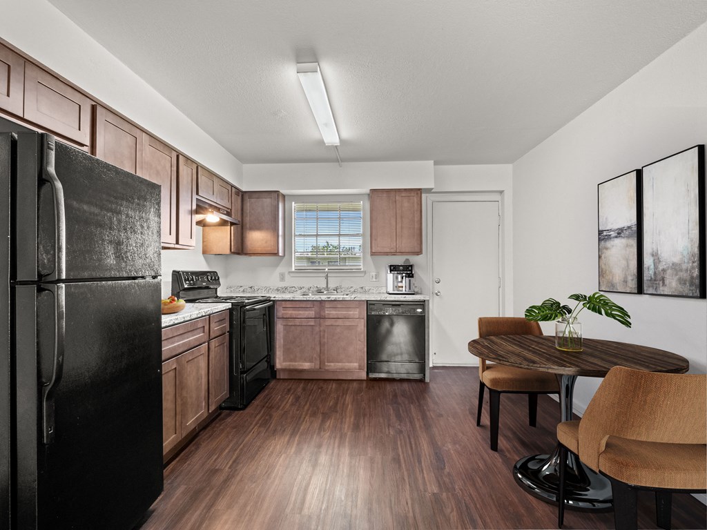 our apartments offer a modern kitchen with stainless steel appliances and a dining room table
