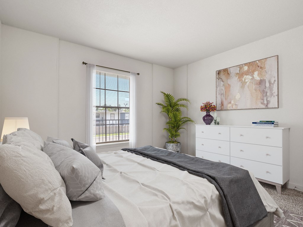 a bedroom with a bed and a dresser and a window