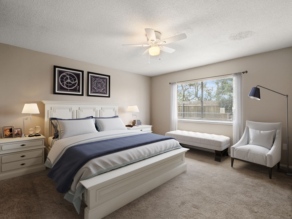 a bedroom with a bed and a ceiling fan