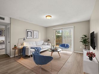 a living room with a couch and chairs and a tv