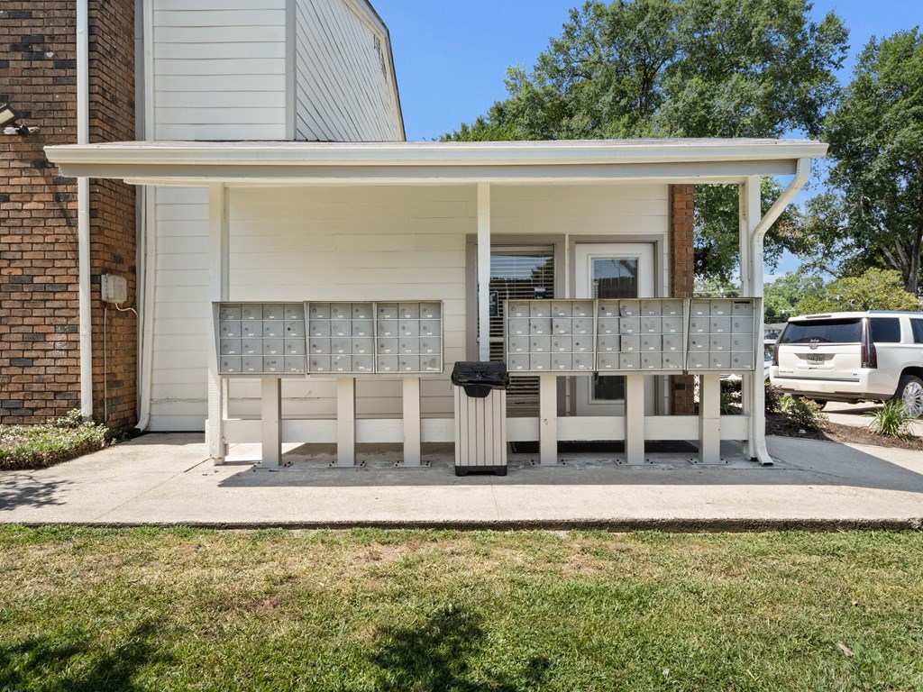 the front porch of a white house with a porch swing