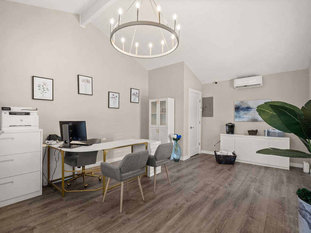 a home office with a desk and a computer in a living room