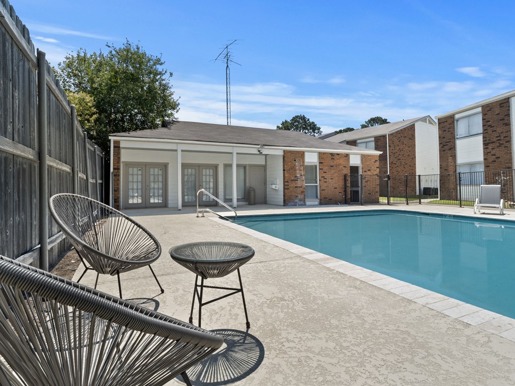 our apartments offer a swimming pool and a patio with chairs