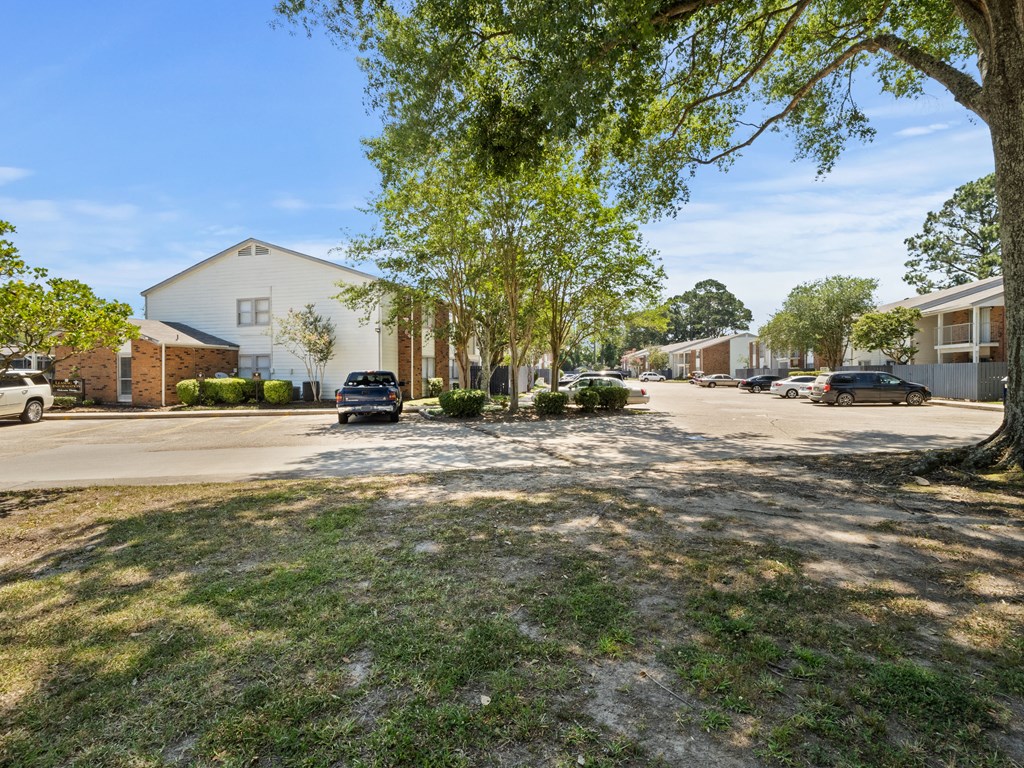the view of a street with houses and trees
