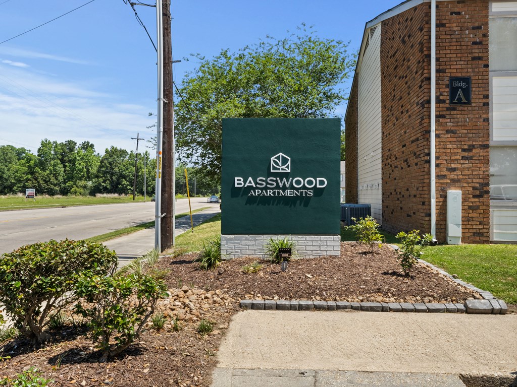 the sign outside of the basswood apartments building
