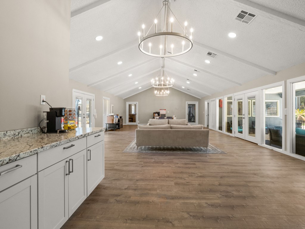 a living room with a couch and a chandelier