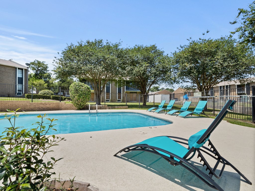 our apartments have a resort style pool and lounge chairs