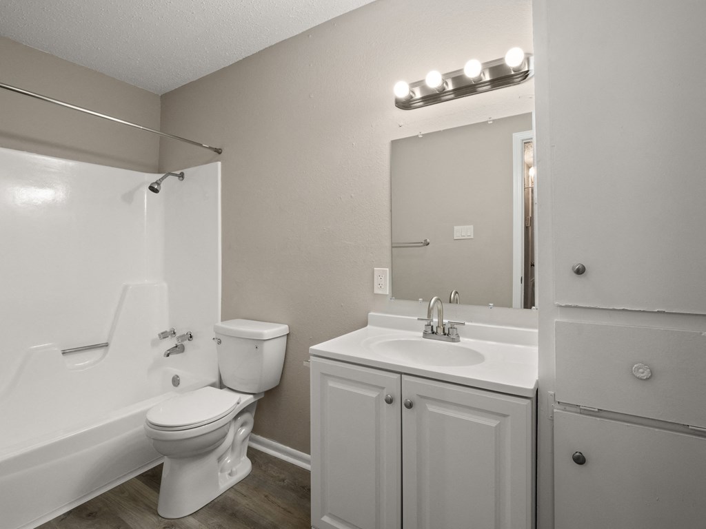 a bathroom with a sink toilet and a mirror