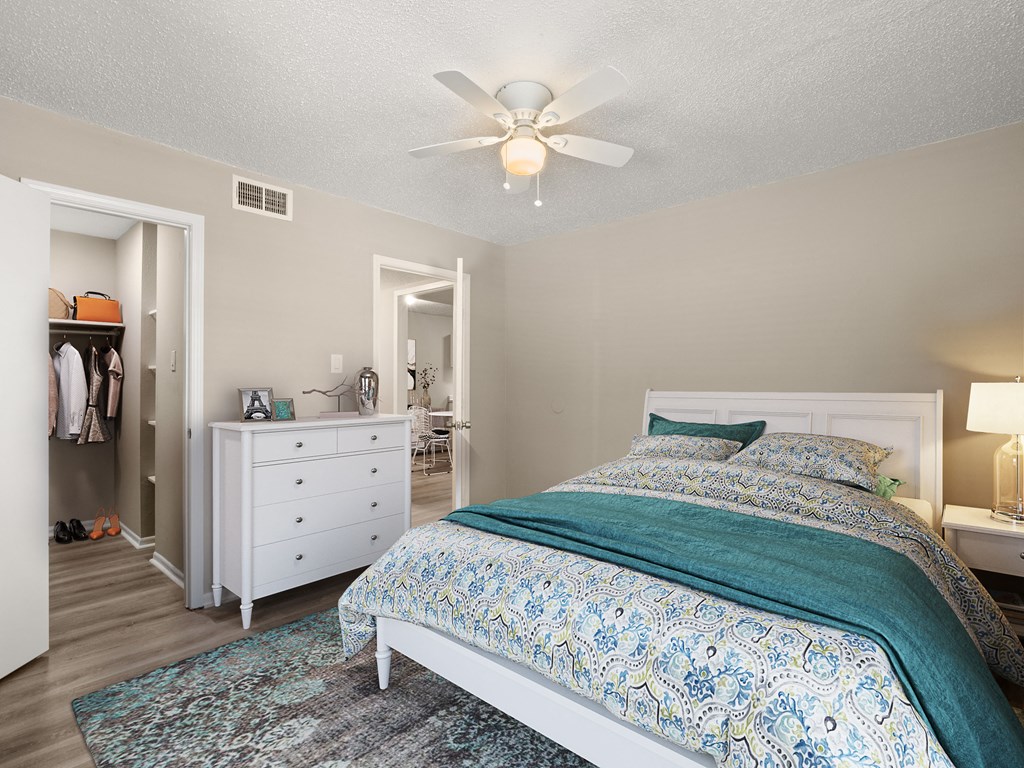 a bedroom with a bed and a ceiling fan