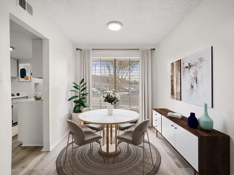 a dining room with a table and chairs and a window