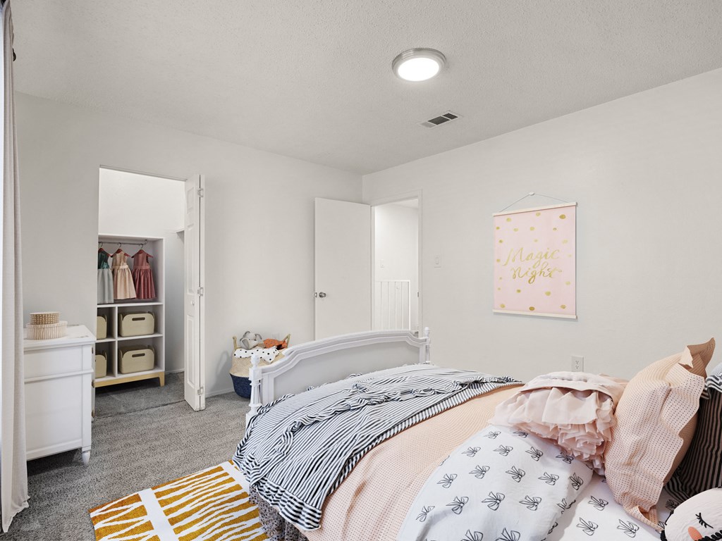 a bedroom with a bed and a closet