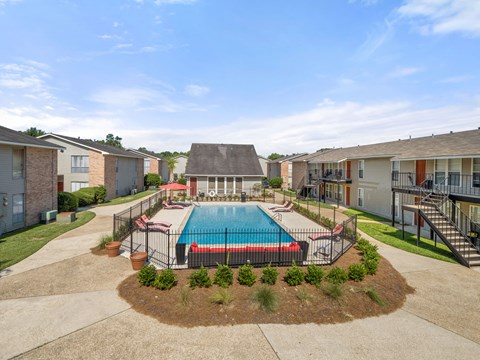 an aerial view of an apartment complex with a swimming pool