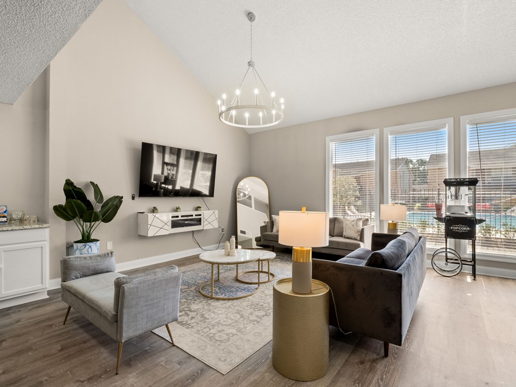 a living room with couches and chairs and a chandelier