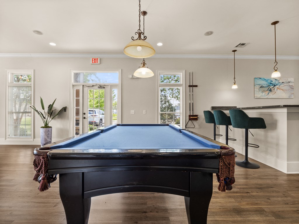an entertainment center with a pool table in a house