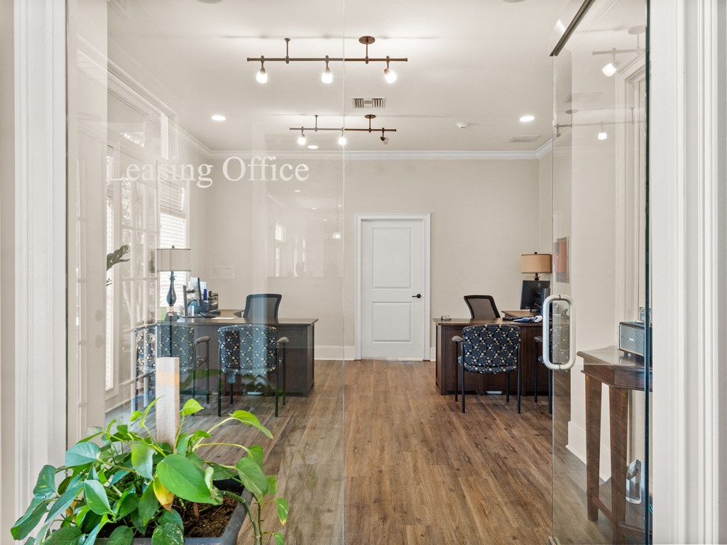 an office with a wooden floor and a glass door