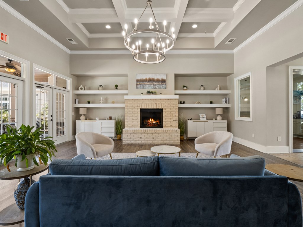 a living room with a couch and chairs and a fireplace