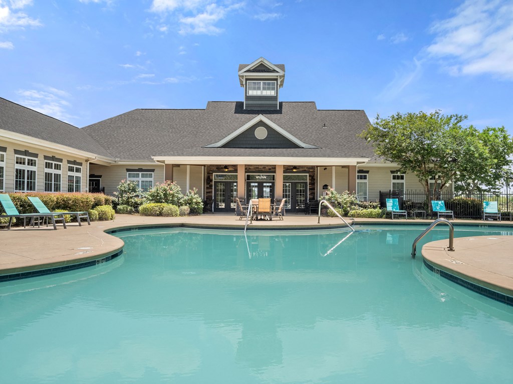a swimming pool with a building in the background