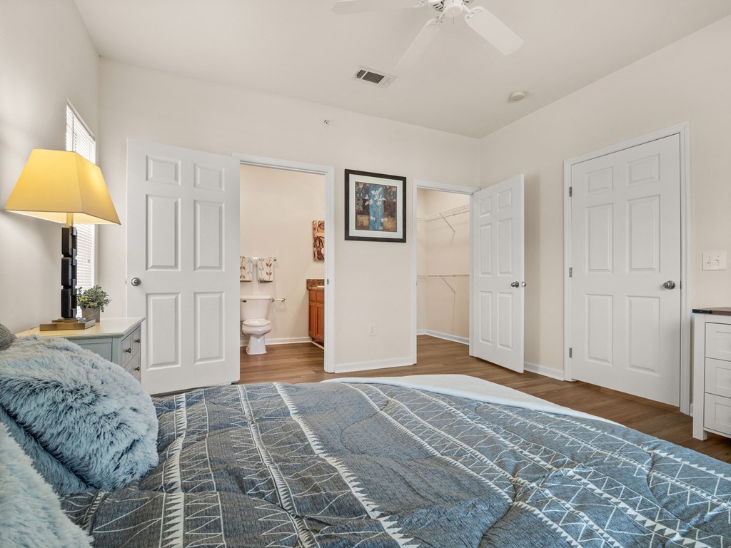 a bedroom with a bed and a bathroom with a toilet