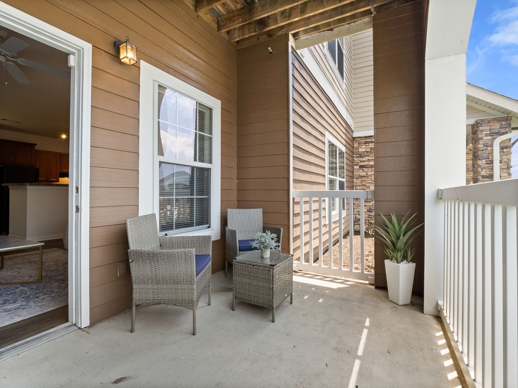 a patio with two chairs and a table on it