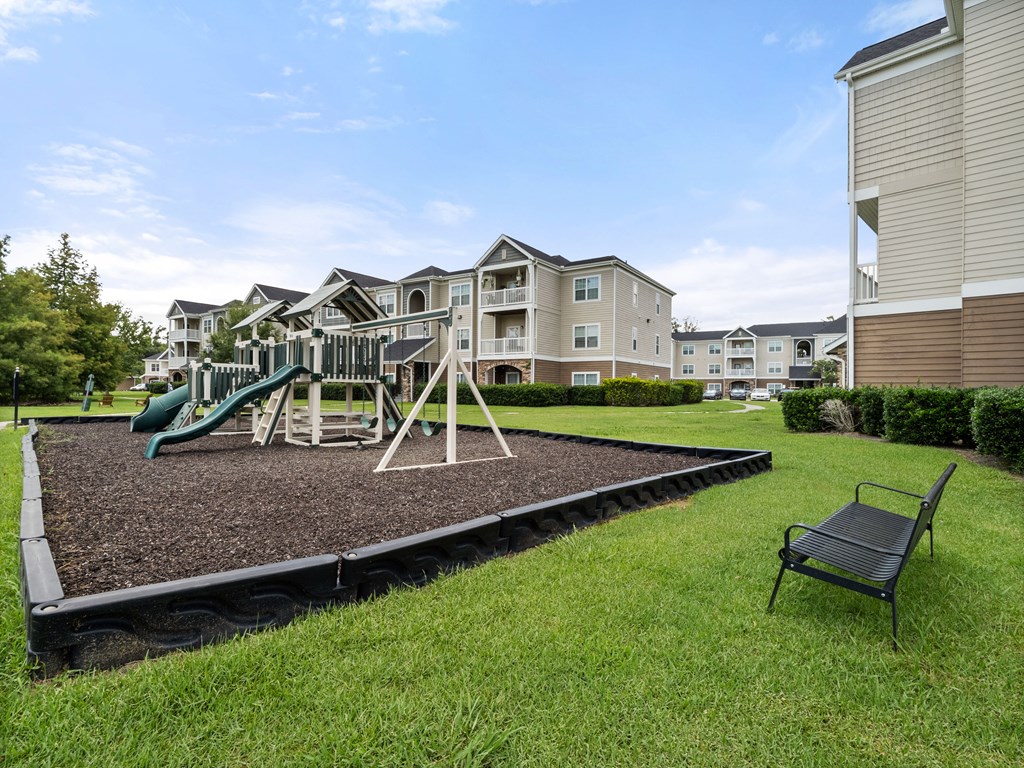the preserve at ballantyne commons playground with swing set and chairs in the grass