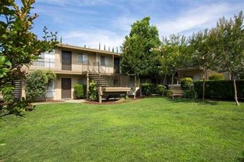 Apartment building with a large grassy courtyard at Abby Creek Apartments, California, 95608