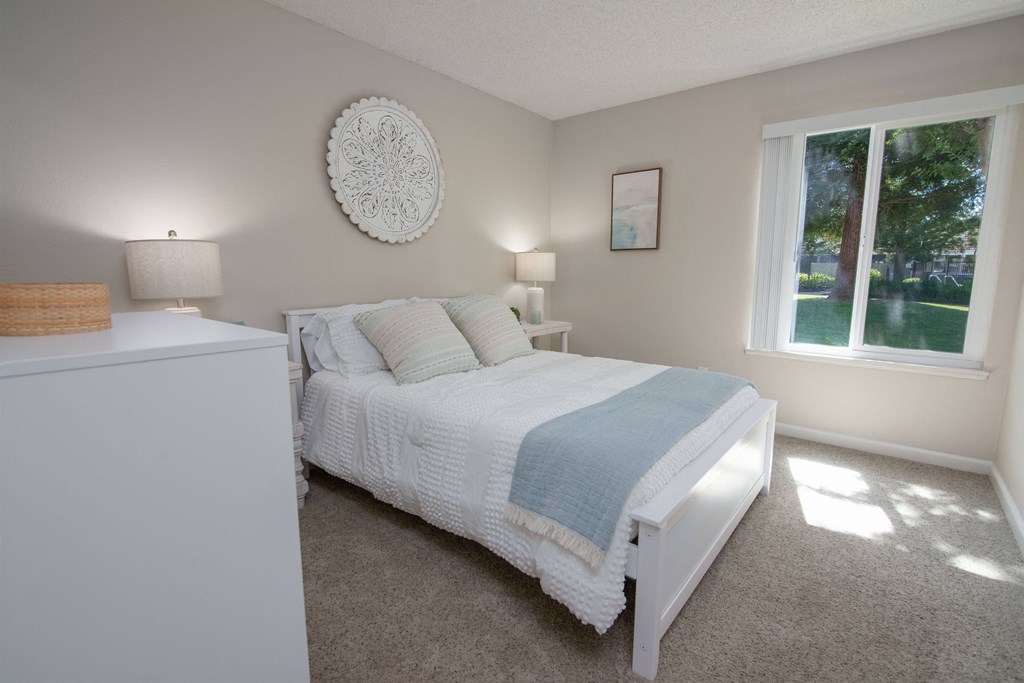 Model apartment Spare bedroom with a bed and a window at Willow Grove Apartments, Sacramento, 95825 
