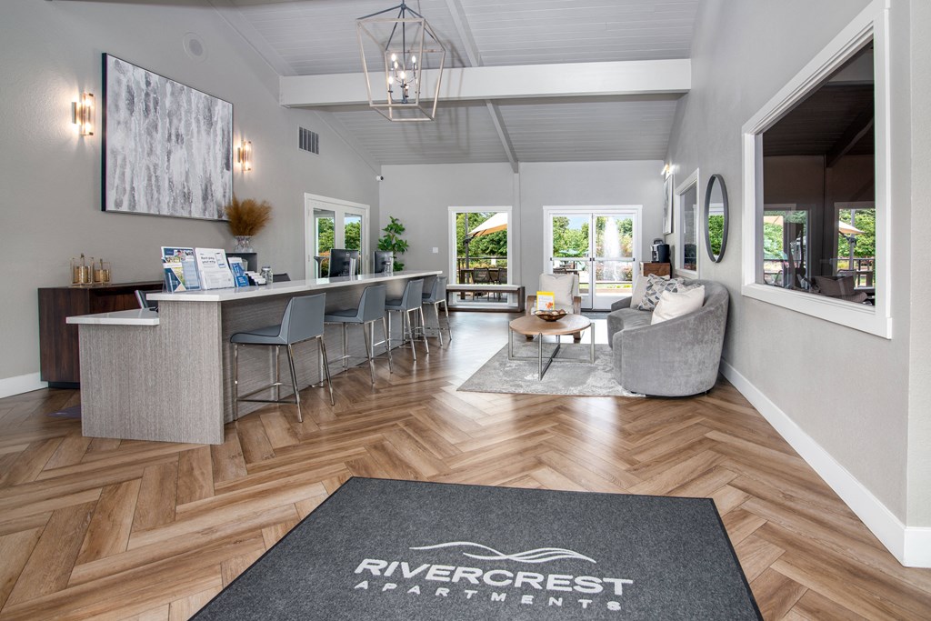 Leasing office with furniture and large windows at Rivercrest Apartments, Sacramento, CA 
