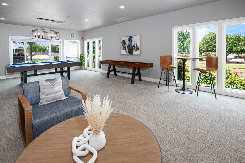 Resident lounge with a billiard table and seating area at Rivercrest Apartments, Sacramento 