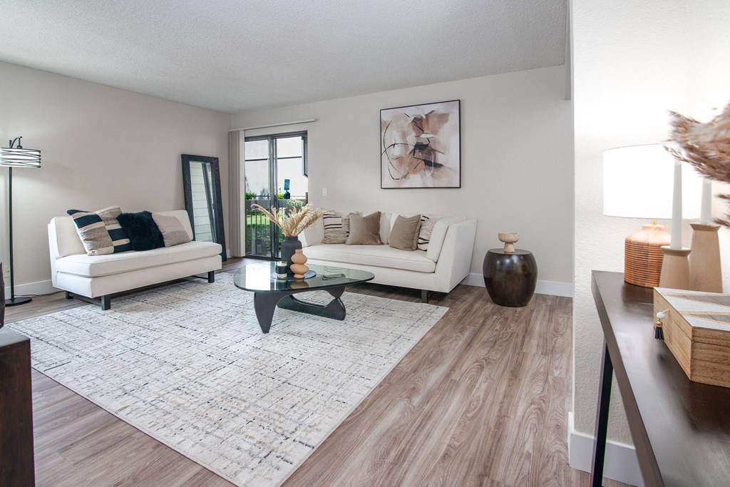 Model apartment living room with two couches and a coffee table at Rivercrest Apartments, Sacramento, 95826 