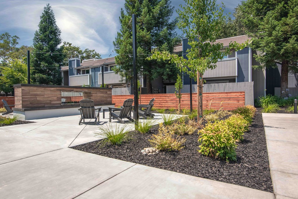 Courtyard with a table and chairs and fireplace  at Willow Grove Apartments, Sacramento, 95825 