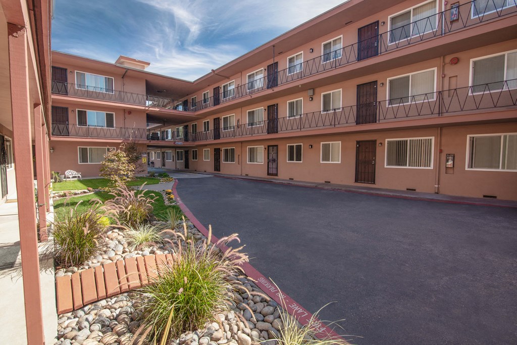 Apartment building with a driveway and courtyard area