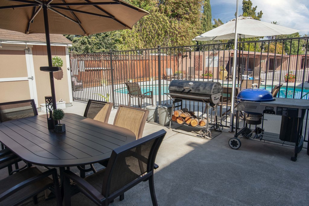 BBQ patio with a table and chairs and BBQs