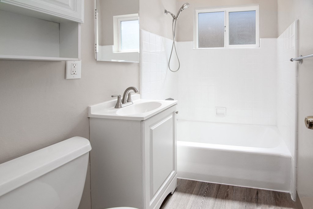 Model bathroom with a sink and a tub and a shower