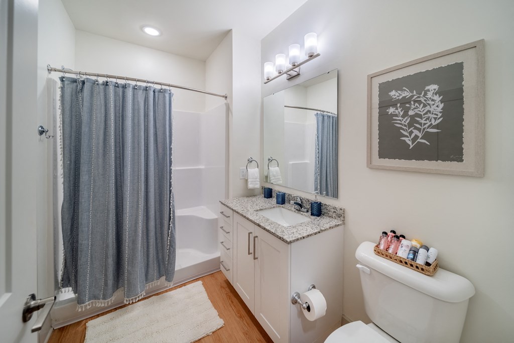 a bathroom with a shower and a sink and a toilet