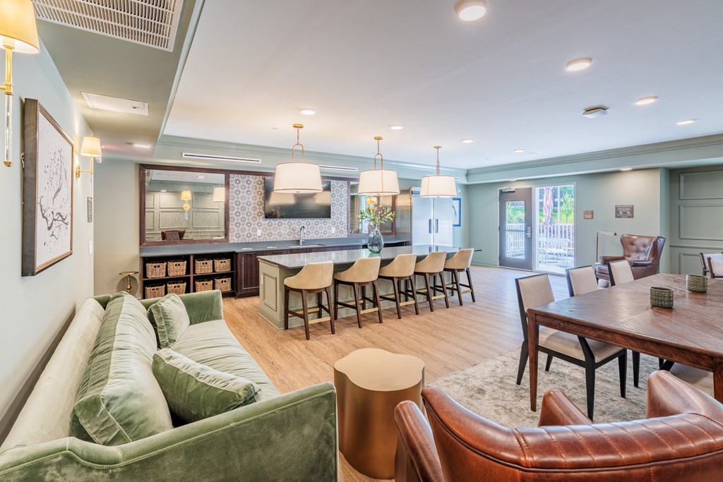 a living room with couches and chairs and a dining table