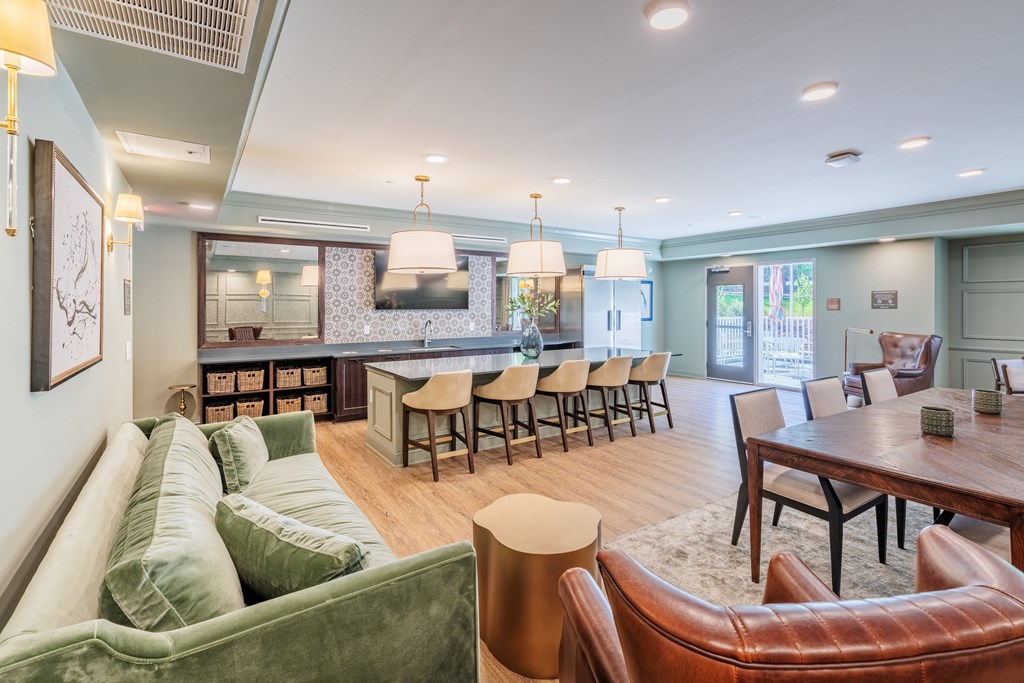 a living room with couches and chairs and a dining table