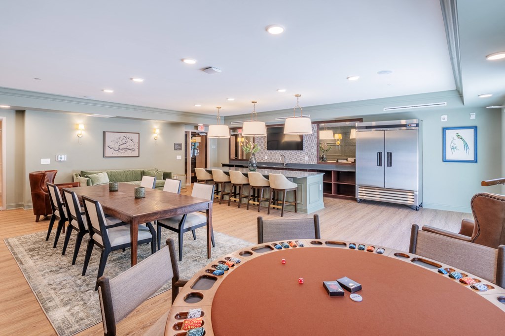 a clubhouse with a poker table and a kitchen